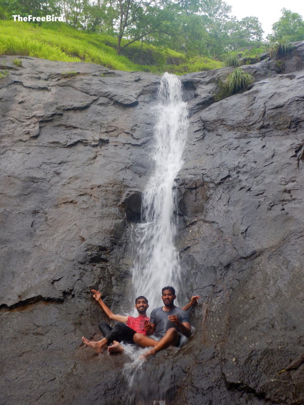 People enjoying the small waterfall
