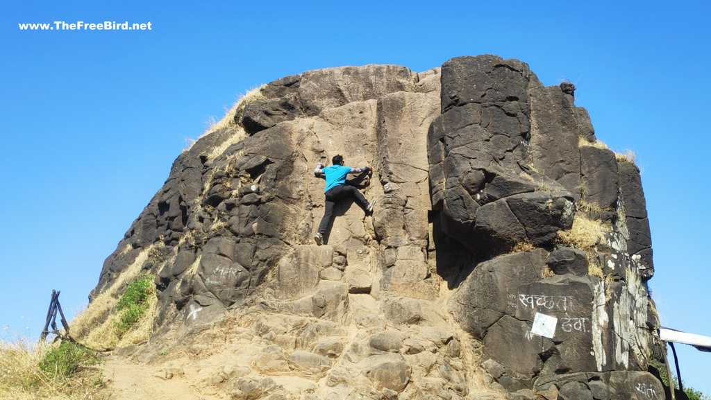 Rock climbing at top of Kalavantin durg trek blog